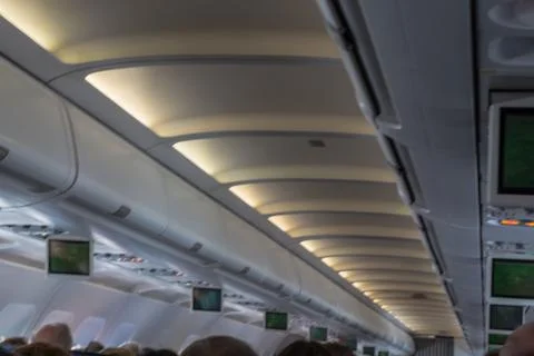 Airplane interior with passengers Stock Photos