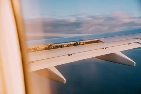Airplane interior with window view of the Baltic sea and clouds. Stock Photos