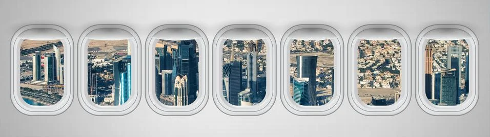 Airplane interior with window view of Doha City. Concept of travel and air tr Stock Photos