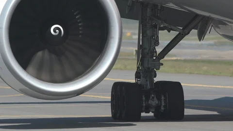 Airplane jet engine and landing gears moving forward Stock Footage 90224374