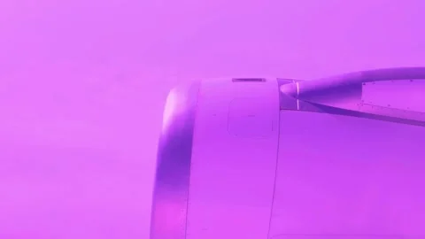Airplane jet engine flying above clouds with dreamy purple filter effect Stock-Footage 341802165