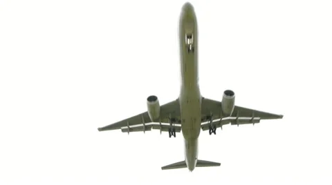 Airplane Jet flying overhead above close Stock Footage