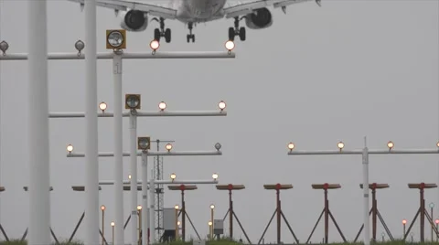 Airplane jet plane approaching and landing at airstrip runway Video stock 48649300