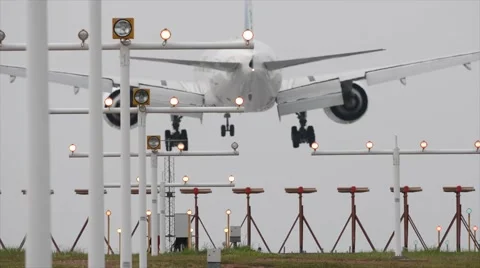 Airplane jet plane approaching and landing at airstrip runway Stock Footage