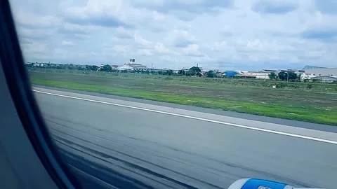 Airplane landing and touching down on runway Stock Footage 333454603