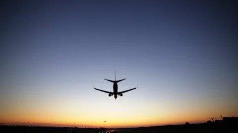 Airplane landing at dusk. Dynamic close up shot filmed in Full HD 1080p. Wide Stock Footage 107722360