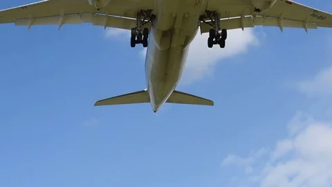 Airplane landing in front of clouds Stock Footage 76563584