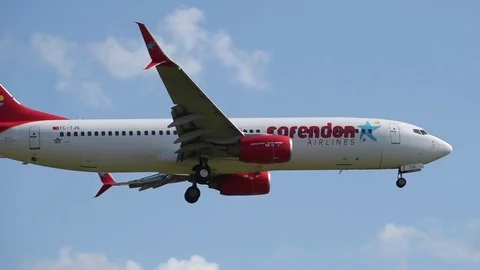 Airplane landing in front of clouds Stock Footage 76565598