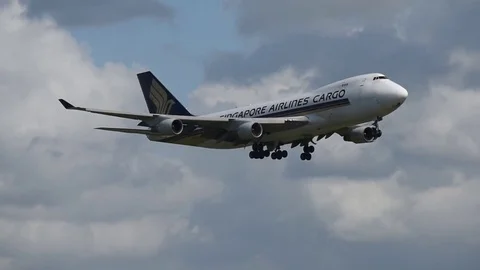 Airplane landing in front of clouds Stock Footage 76565891