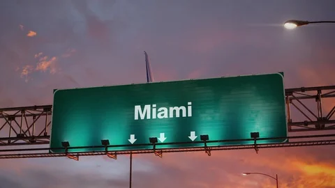 Airplane Landing Miami during a wonderful sunrise Stock Footage