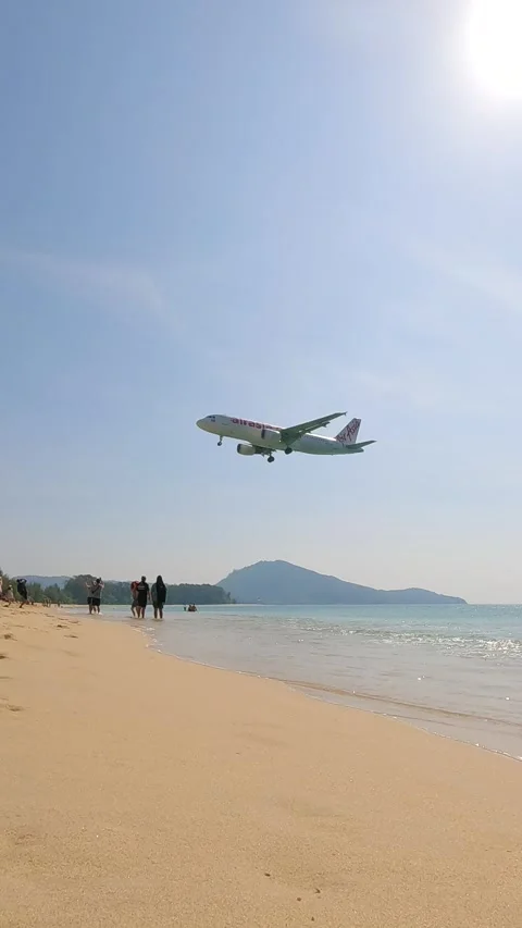 Airplane landing over ppular beach at Phuket Thailand Stock Footage 327472530