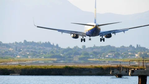 Airplane landing on runway two second before touchdown in rear view Stock Footage 112351744