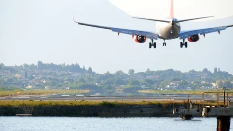 Airplane landing on runway two second before touchdown in rear view Stock Footage 112351856