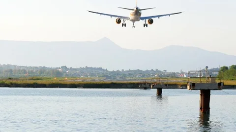 Airplane landing on runway two second before touchdown in rear view Stock Footage 112351928
