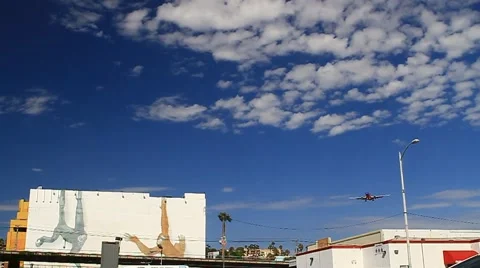 Airplane landing with shadow on building 스톡 동영상 50521765