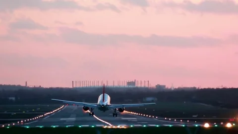 Airplane landing in the sunset Stock Footage 71059855
