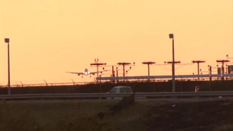 Airplane Landing at Sunset Stock Footage 78937928