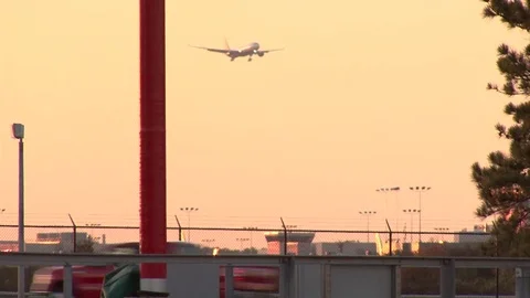Airplane Landing at Sunset Stock Footage 78937941
