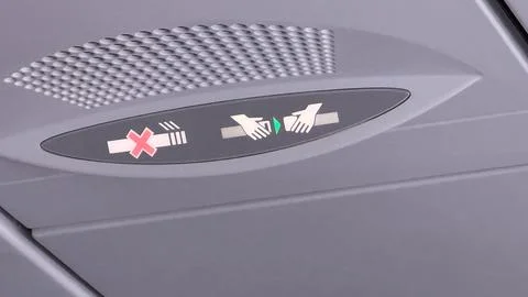 Airplane lavatory occupancy indicator with red cross and hands symbols on gre Stock Photos