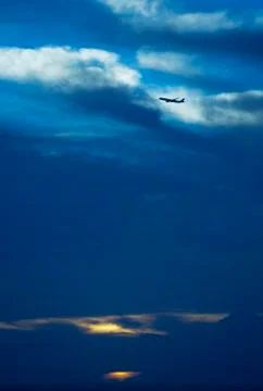 Airplane leaving Hawaii at sunset Stock Photos