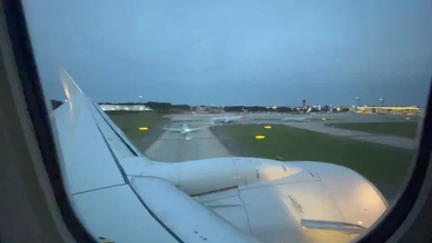 Airplane making a landing at sunset Stock Footage 163942747