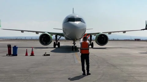 Airplane marshaller guide a jet in AIFA airport, Mexico City, Mexico 4K Stock Footage 300619355