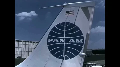 An airplane mechanic admires the engines on a Pan Am jet, and shares some of its Stock Footage