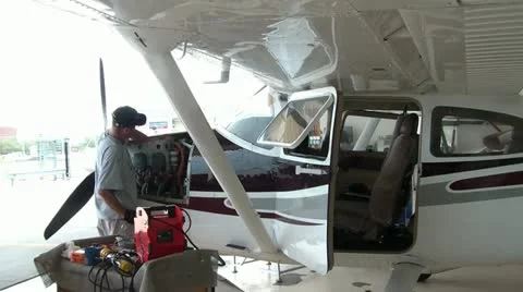 Airplane Mechanic Working on Engine Video stock 12570893