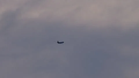 Airplane in mid-turn entering clouds Stock Footage 270144997