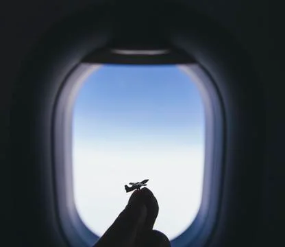 Airplane model at the airplane window background Stock Photos