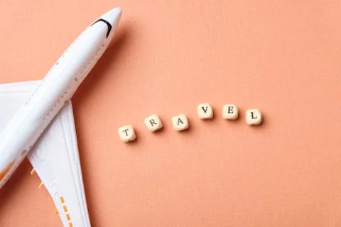 Airplane model and clouds. Text Travel. Fly by plane Stock Photos