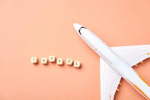 Airplane model and clouds. Text Travel. Fly by plane Stock Photos