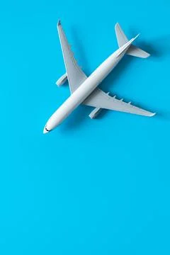 Airplane model on a blue background isolated, flat lay. Stock Photos