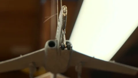 Airplane model hangs on thread under blockhouse ceiling Video stock 127377965