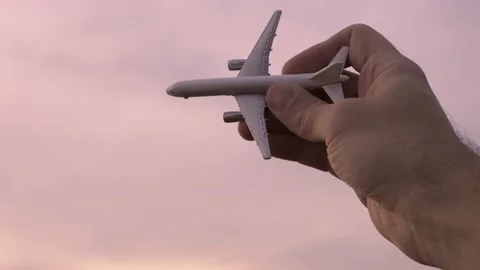 Airplane model in a male hand in the background sky. Stock Footage 169408788