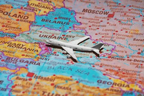 Airplane model over the map of Ukraine representing air travel and airspace s Fotos Stock