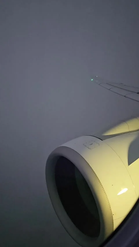 An airplane moving through a cloud layer during a sunset flight over Europe. Vie Stock Footage 335317700