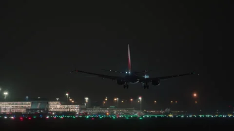 Airplane Night Landing and Touchdown on Wet Runway Stock Footage 346390451