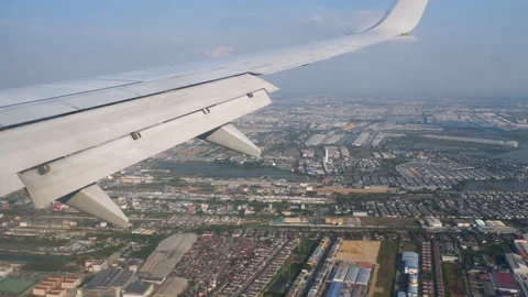 Airplane over the city, view from the window Stock Footage 233151727