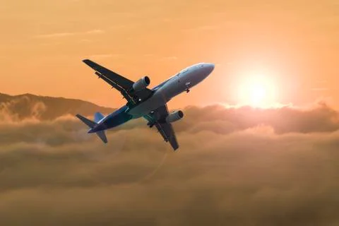 Airplane over the clouds Stock Photos