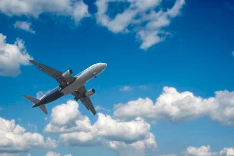 Airplane over the clouds Stock Photos