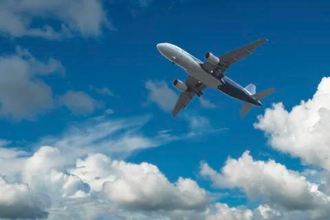 Airplane over the clouds Stock Photos
