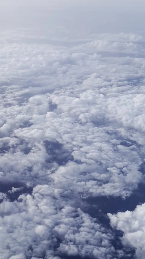 Airplane Over Cloudscape With Fluffy Clouds and Blue Sky Stock Footage 330731391
