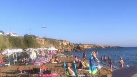 Airplane over a crowded summer beach Ammes in Kefalonia island in Greece Stock Footage 151304455