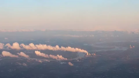 An airplane over a river with power plants 4k 30fps video Stock Footage 257577527