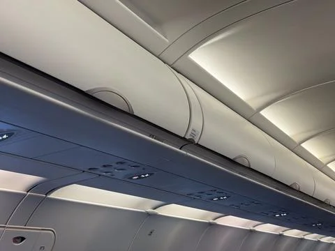 Airplane overhead compartments and ceiling. Aviation design, passenger serv.. Stock Photos