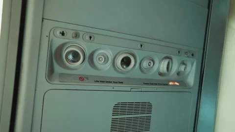 Airplane overhead panel with reading lights and air vents close up Stock Footage 347830313