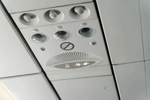 Airplane Overhead Panel with Reading Lights and No Smoking Sign Stock Photos