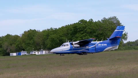 Airplane with Parachutists is Preparing to Take Off, Picking Up Speed by Grass Stock Footage 154613414