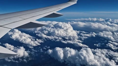 Airplane Passenger Point of View, Flying Above Clouds on Sunny Day, Wing and Stock Footage 346866229